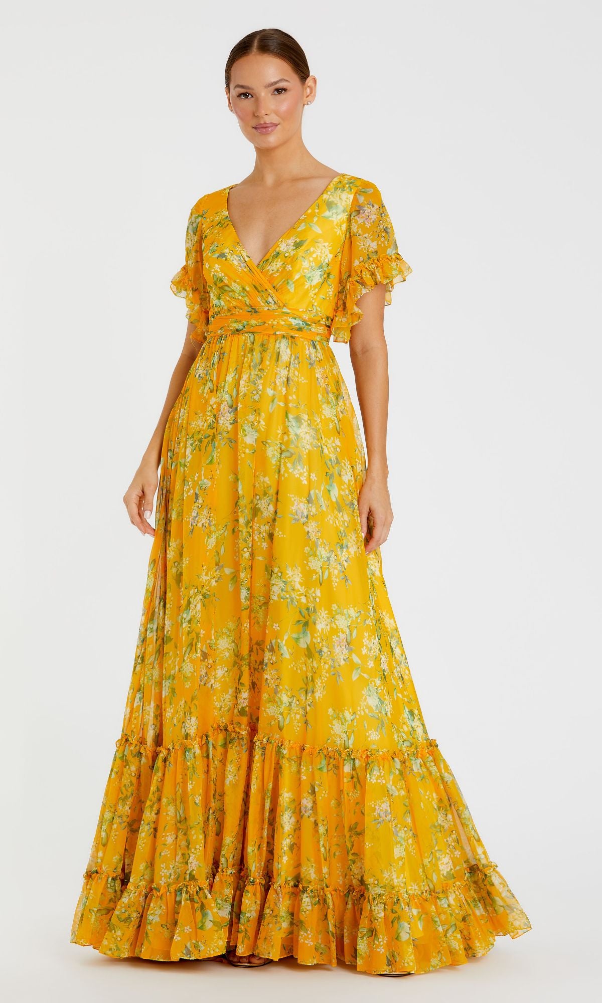 A woman models the Floral-Print Long Formal Dress: 70241 Mac Duggal—yellow, bohemian style with short flutter sleeves, V-neckline, and tiered ruffle hem—against a plain white background.